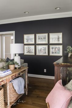 a living room filled with furniture and pictures on the wall above it's coffee table