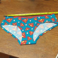 Show Off Your Superhero Side With These Fun Superman Hipster Panties! Made By Briefly Stated Under An Official Warner Brothers License, These Panties Are Crafted From A Comfortable Blend Of 95% Cotton And 5% Spandex Jersey For A Soft, Stretchy Fit. They Are A Size Medium And Come Brand New In A Gift Box, Perfect For Gifting Or Adding To Your Own Collection. The Panties Were Only Removed From The Box For Photographs, So They're In Pristine Condition. The Gift Box May Show Minor Wear, But The Pant Warner Brothers, The Gift, Cotton Spandex, Superman, Women's Intimates, Red And Blue, Gift Box, Spandex, Size Medium