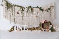 the backdrop is decorated with flowers and greenery