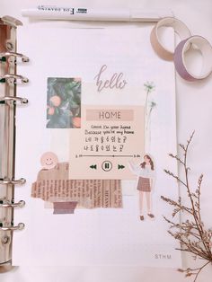 an open planner with stickers on it next to a plant and some other items