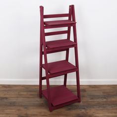 a red wooden shelf with three shelves on it