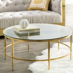 a living room with a couch, coffee table and two books on top of it