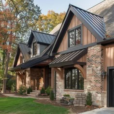 a brick house with metal roofing and windows