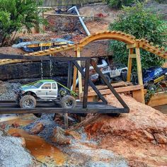 a toy truck driving across a wooden bridge