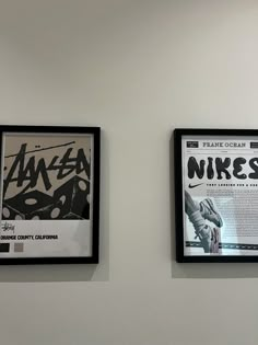 two black and white framed posters on the wall