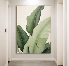 a painting hanging on the wall in an empty room with a plant next to it