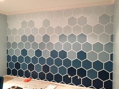 a room with blue and white hexagonal tiles on the wall, along with construction tools