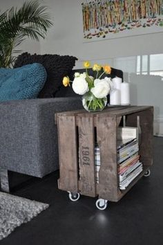 a living room with a couch, coffee table and flower arrangement on the end table