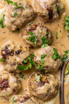 meatballs covered in gravy and garnished with parsley