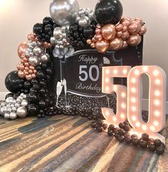 the 50th birthday sign is surrounded by balloons