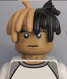 a close up of a lego figure with black hair