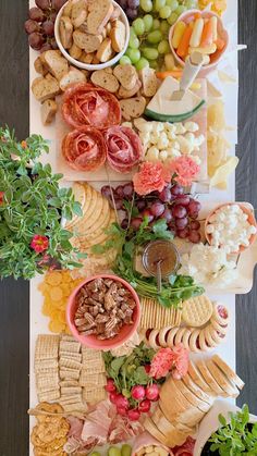 a table topped with lots of different types of food and snacks on top of it