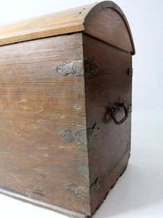 an old wooden box is sitting on the floor