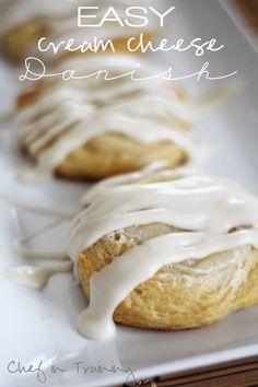 a white plate topped with donuts covered in icing and drizzled