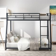 a black metal bunk bed with white sheets and pillows