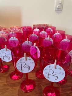 red wine glasses with labels on them sitting on a table