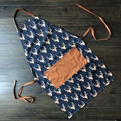 a blue and white apron with deer on it