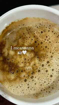 there is a cup of coffee with the word i mean mmm written in small letters