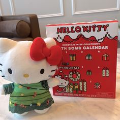 a hello kitty plush toy next to a christmas card