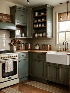 a kitchen with green cabinets and white appliances