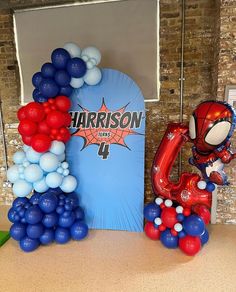 balloons are arranged in the shape of letters and spider - man balloon arch for a birthday party