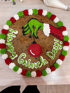 a decorated cookie with the words happy grin on it and an image of a hand