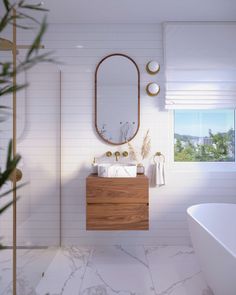 a bathroom with a sink, mirror and bathtub next to a plant in the corner