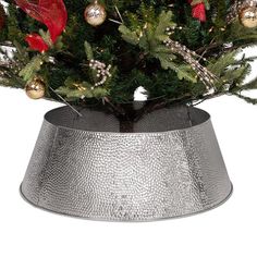 a small christmas tree in a silver pot