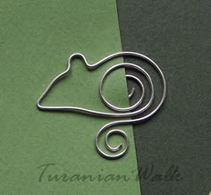 a close up of a metal object on a green and black surface with the word taranna written below it