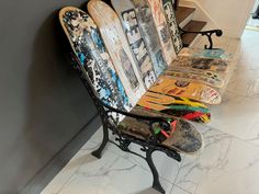 several skateboards are lined up on a bench in a room with marble flooring