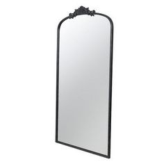 a large mirror sitting on top of a white wall