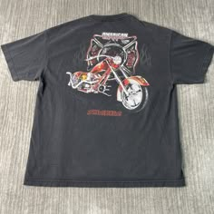 Vintage 2000s American Choppers Motorcycle Biker Double Sided Y2K Aesthetic Streetwear Black Graphic T Shirt Extra Large Mens Condition:  Excellent Used Condition  = No Flaws Measurements: Please see photos above for all measurements IF YOU BUY TWO OR MORE ITEMS USE THE CODE BUNDLE @ CHECK TO SAVE 20% WE SHIP WITHIN 24 HOURS AFTER PURCHASE! Please be aware that we do not offer free returns!! The Buyer is responsible for the cost of the return label.  Follow us on TikTok & Instagram @findsnostalg Cheap Y2k Style Men's T-shirt, Mens Biker Style, Graphic Tees Men, Motorcycle Shirts, Vintage Rock Shirt, Black Biker T-shirt With Graphic Print, Vintage Motorcycle Shirt, Retro Graphic Print T-shirt For Biker Events, American Chopper