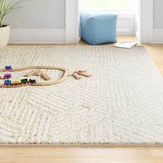 a child's toy train set sitting on top of a rug