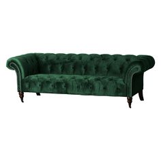 a green velvet couch with wooden legs and nail polishing on the armrests