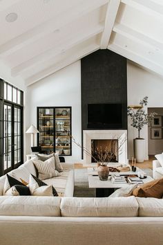 a living room filled with furniture and a fire place in the middle of a room