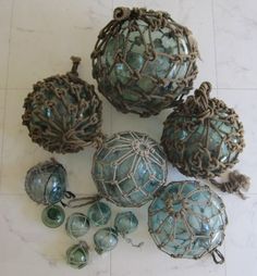 five antique glass ornaments are on the floor