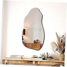 a mirror sitting on top of a wooden table