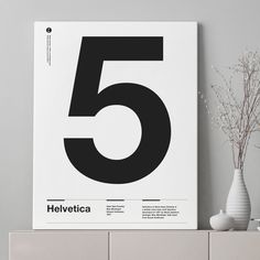 a white poster with the number five on it next to some vases and flowers