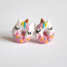 pair of unicorn donuts with sprinkles on white background