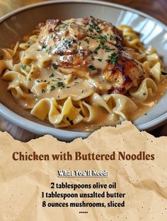 chicken with buttered noodles in a white bowl on a wooden table next to a piece of parchment paper