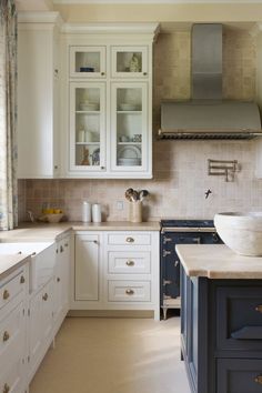 Classic white kitchen with gold handles, stone counter tops, and vintage stove in the kitchen Sophisticated Kitchen, Natural Stone Counter, Stone Counter, Colored Walls