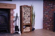 a firewood rack sitting in front of a fireplace next to a potted plant