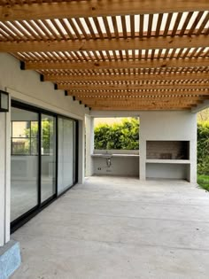 an outdoor covered patio area with sliding glass doors