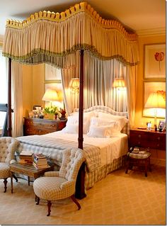 a four poster bed sitting in a bedroom next to a window