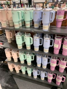 the shelves are filled with many different colored coffee mugs and one is on display