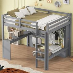 a bunk bed with a desk underneath it in a room that has yellow walls and wooden floors