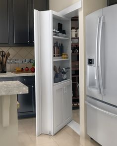 an open refrigerator in a kitchen next to a counter