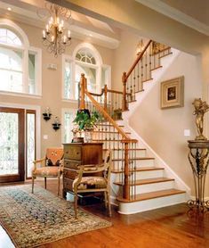 a living room filled with furniture and a stair case