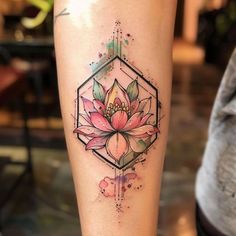 a woman's leg with a tattoo on it and a pink flower in the center