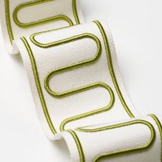 two white and green ribbon with lines on them, one in the shape of a letter